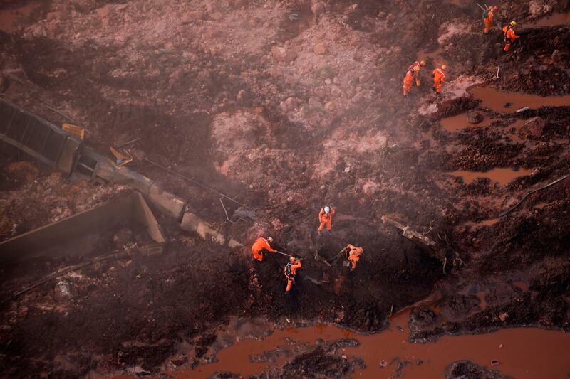 Rescuers work in the search for victims after the collapse of a dam unleashed a torrent of mud on a riverside town and surrounding farmland on Friday, destroying houses, leaving 200 people missing and raising fears of a number of deaths. AFP