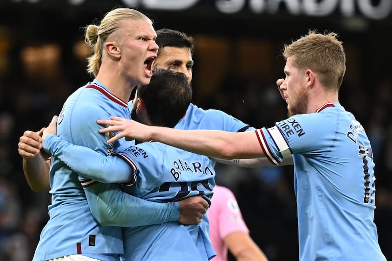 Manchester City striker Erling Haaland celebrates with teammates after scoring the opening goal. AFP