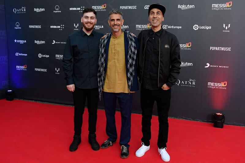 Guillermo Bonetto, centre, and Claudio Illobre, right, of Argentinian reggae band "Los Cafres" pose on the red carpet. AFP