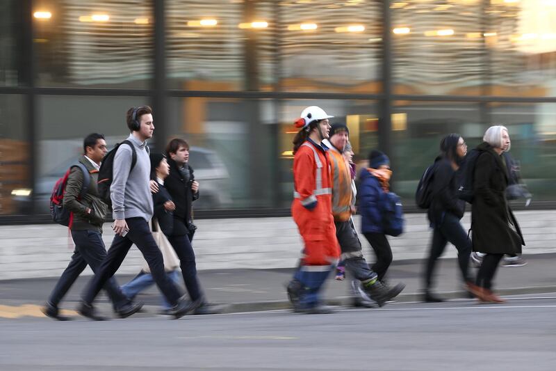 People make their way into the CBD during the first day under COVID-19 Alert Level 1 in Wellington, New Zealand. Getty Images
