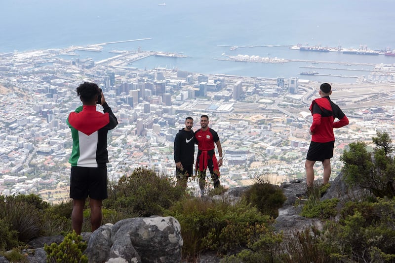 Palestinian national football team defenders Bashar Shobaki, left, and Ali Rabei, right, pose for a photograph from the top of Table Mountain, in Cape Town. AFP