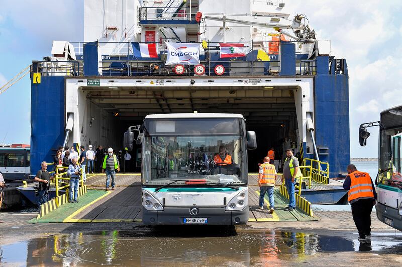 A bus donated by the French government to the Lebanese public transport sector is unloaded from a cargo ship at the Port of Beirut, Lebanon, 23 May 2022.  The first batch consists of 50 buses donated to help develop Lebanon's public transport plan.   EPA / WAEL HAMZEH