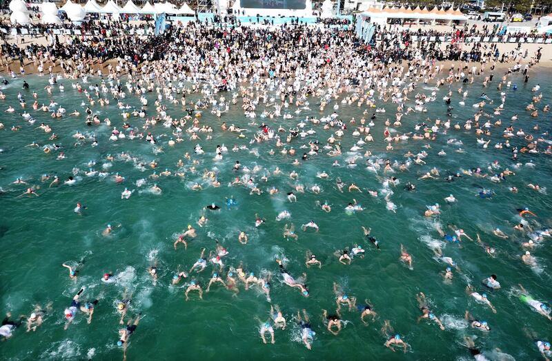 Participants plunge into the sea during the 33rd Polar Bear Festival at Haeundae Beach in Busan, South Korea,  on Sunday, January 5. EPA