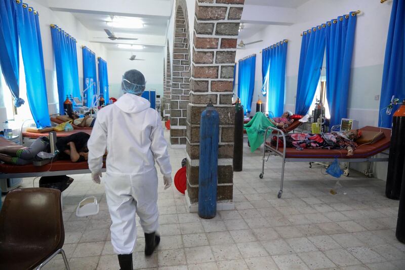 A Yemeni member of the medical staff in a full hazmat suit walks in the patient ward at  a quarantine center where Covid-19 patients are treated in Yemen's third city of Taez.  AFP