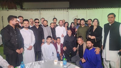 Faisal Niaz Tirmizi, Pakistan's Ambassador to the UAE, (seated centre in black) meets Pakistani social media influencers and businessmen to spread the message warning people against travelling to the Emirates without authentic papers and funds to cover their stay. Photo: Pakistan Embassy in Abu Dhabi