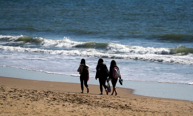 People walk on the beach in Bournemouth. AP Photo