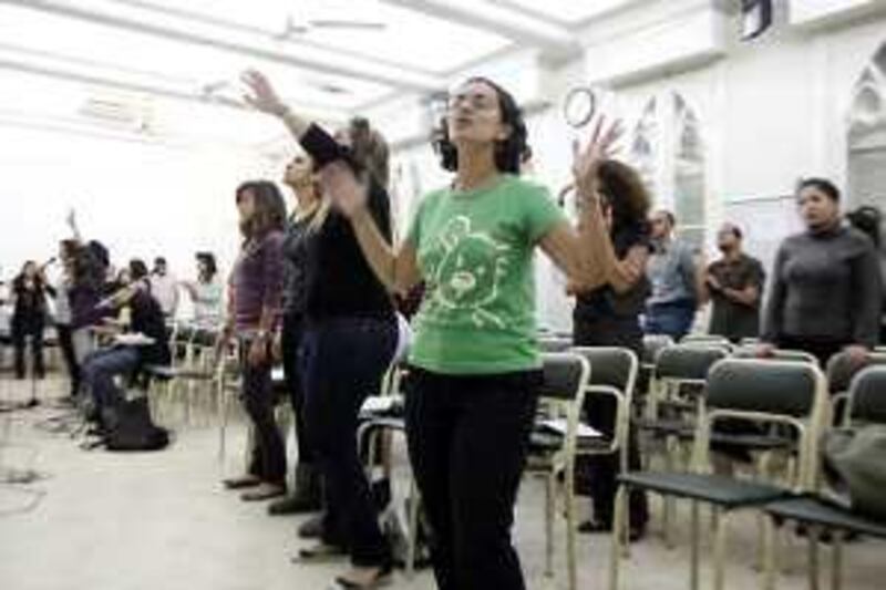 Evangelical Egyptians attend a prayer meeting where the mostly young church goers sing modern songs accompanied by an electric guitar and keyboard.