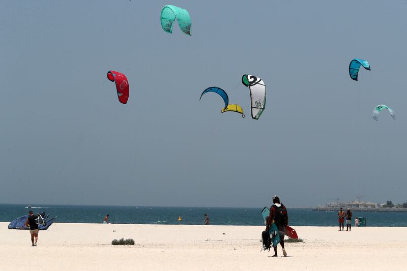 Kite surfers in action at the Kite and Surf beach in Dubai. Pawan Singh / The National