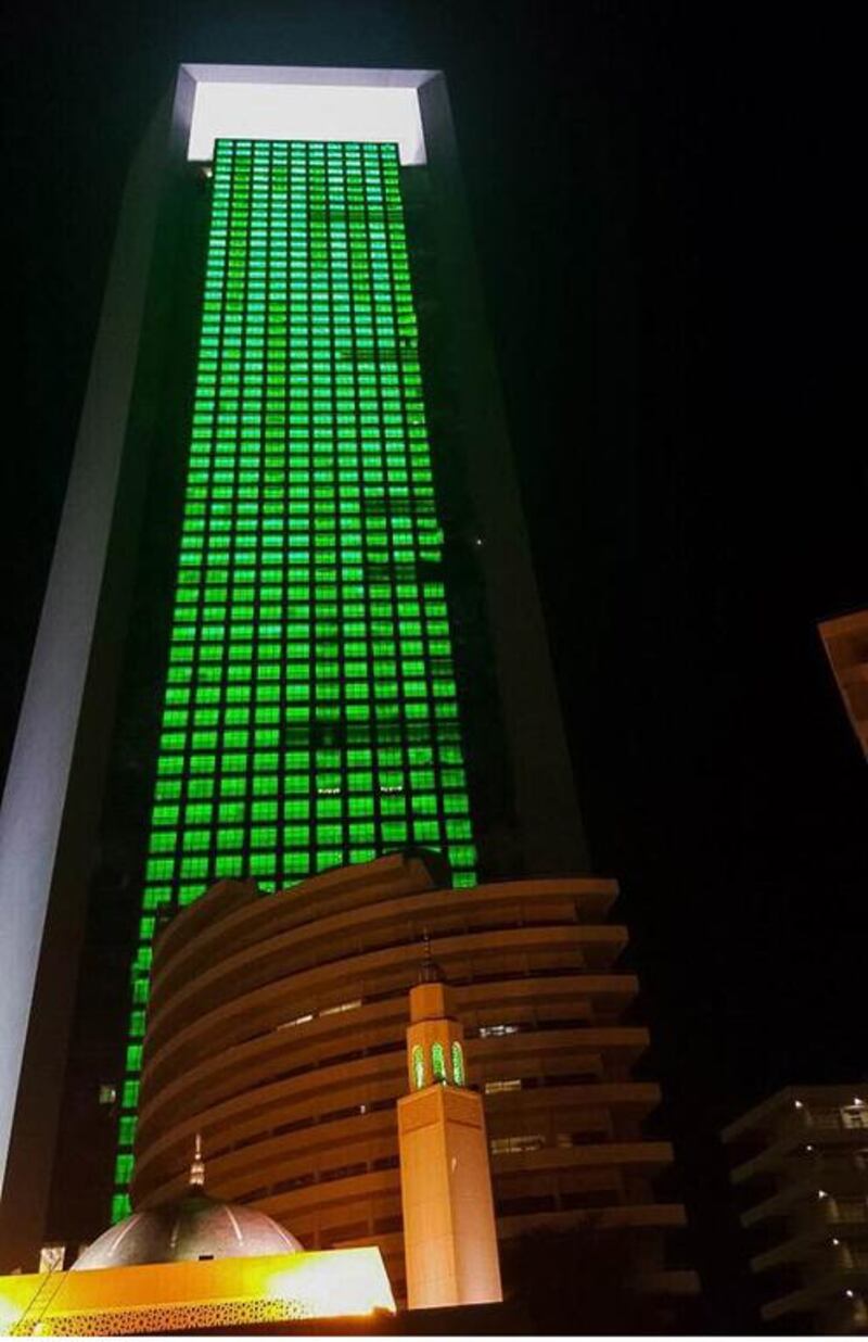 The Adnoc headquarters radiates green light in celebration of Saudi National Day. Wam