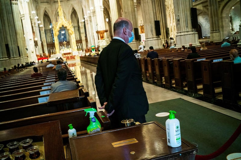 Hand sanitisers and germ killer spray are seen inside St Patrick's Cathedral as Cardinal Timothy Dolan celebrates mass in the Manhattan borough of New York City. Reuters
