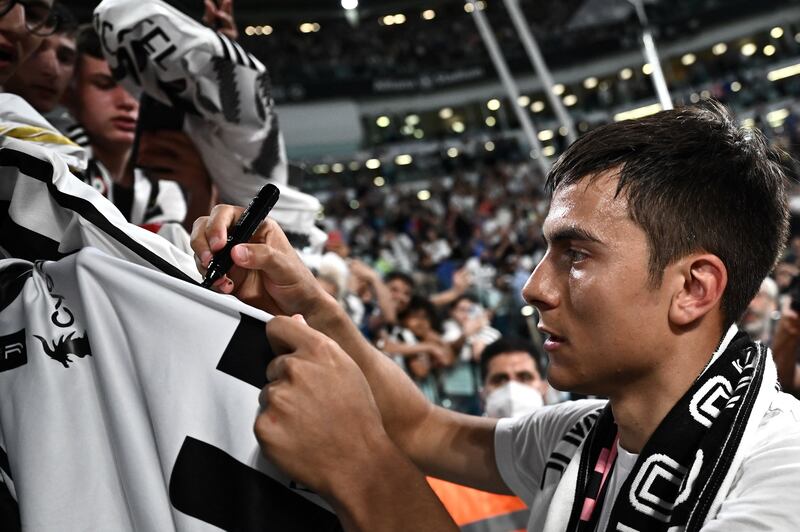 Juventus forward Paulo Dybala from Argentina signs autographs for supporters. AFP