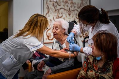 A woman receives a dose of Covid-19 vaccine at a nursing home in Carcavelos, Portugal. AFP