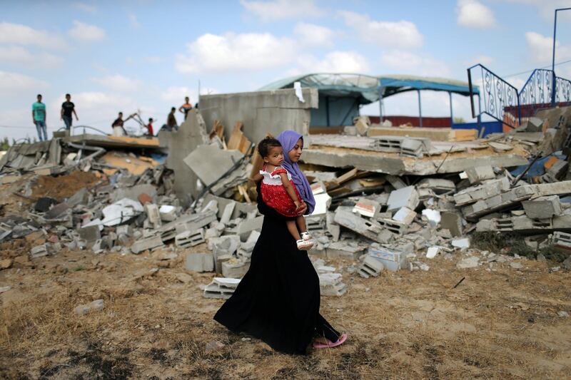 A woman walks past the site of an Israeli air strike in Khan Younis. Reuters