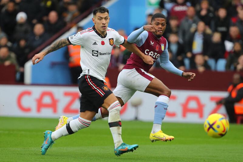 Striker Leon Bailey scores Villa's first goal under pressure from Manchester United's Lisandro Martinez. AFP