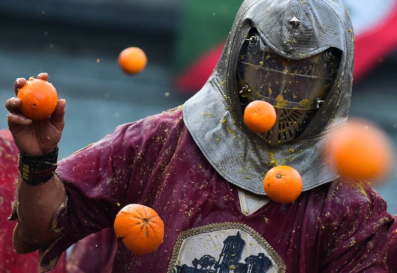 A person participates in the annual 'Battle of the Oranges' in the northern city of Ivrea, Italy February 19, 2023.  REUTERS / Massimo Pinca