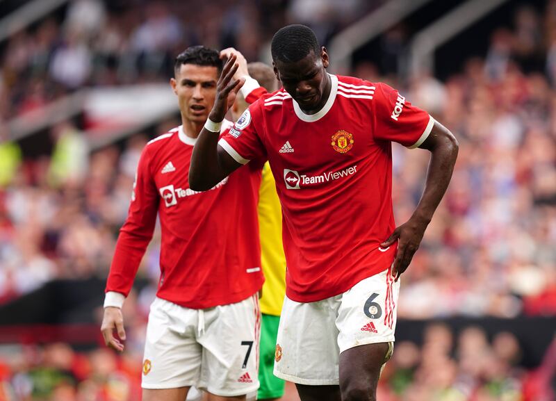 Manchester United's Paul Pogba, right, reacts after a clash of heads during the Premier League match against Norwich at Old Trafford in April 2022. PA