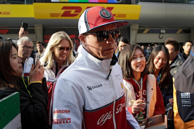 Alfa Romeo driver Kimi Raikkonen of Finland is surrounded by Chinese fans as he attends an autograph session at the Shanghai International Circuit ahead of the Chinese Formula One Grand Prix in Shanghai, China, Thursday, April 11, 2019. (AP Photo/Andy Wong)