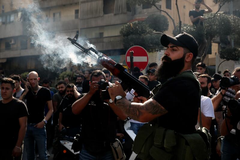 A supporter of the Shiite Amal group fires into the air during funeral processions in the southern Beirut suburb of Dahiyeh. AP