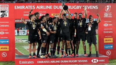 New Zealand celebrate with the trophy after winning the 2018 Dubai Rugby Sevens. AFP