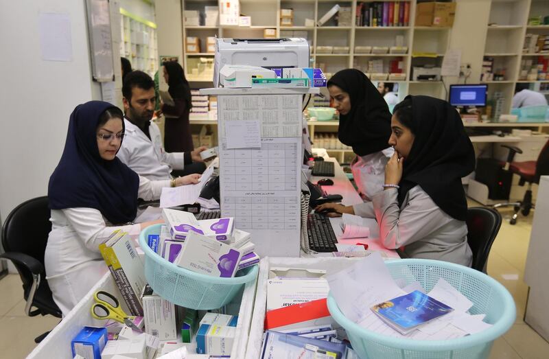 Iranian medical staff work at the state-run pharmacy in Tehran, amid reports of scarce medicine supplies in the country. AFP