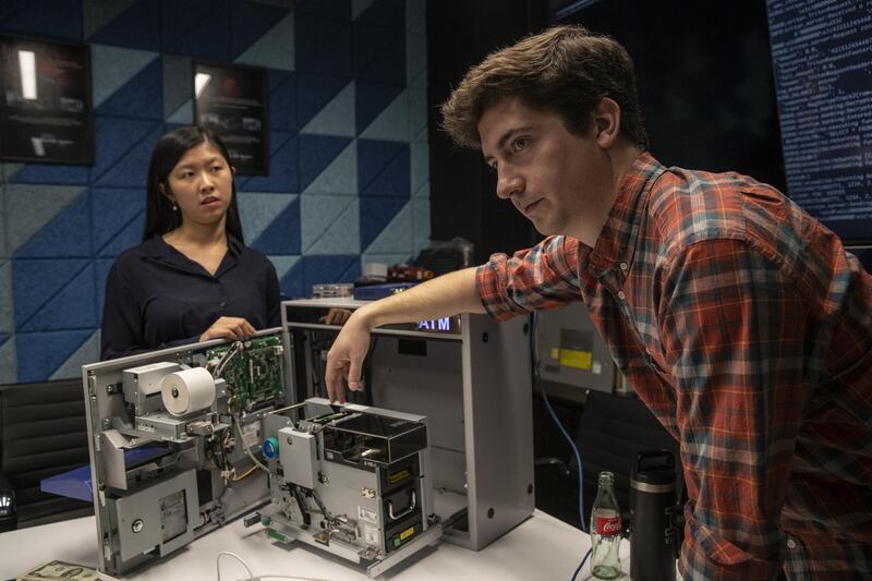 Trey Keown, security researcher for Red Balloon Security Inc., and Brenda So, research scientist for Red Balloon Security Inc., left, demonstrate flaws discovered in Nautilus Hyosung America Inc. automatic teller machines (ATM) in New York, U.S., on Thursday, Nov. 7, 2019. A pair of security researchers at New York based firm Red Balloon Security have discovered two vulnerabilities in ATMs used widely across America that could allow a determined criminal to steal customer data and dispense money from an ATM. Photographer: Victor J. Blue/Bloomberg