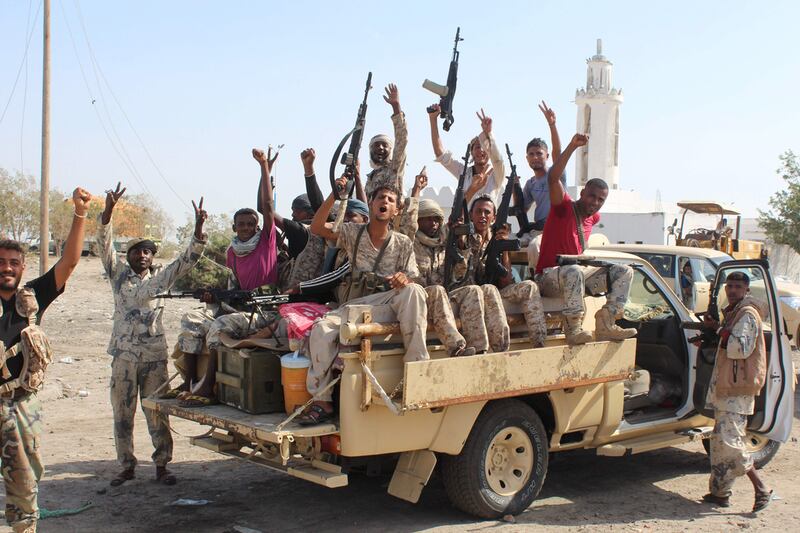 Pro-government forces flash victory signs as they join an operation to drive Al Qaeda fighters out of the capital of the southern Yemeni province of Abyan in April 2016. AFP