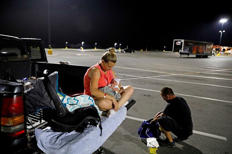 Lorrainda Smith sits with Luke on the back of a pick-up truck. AP Photo