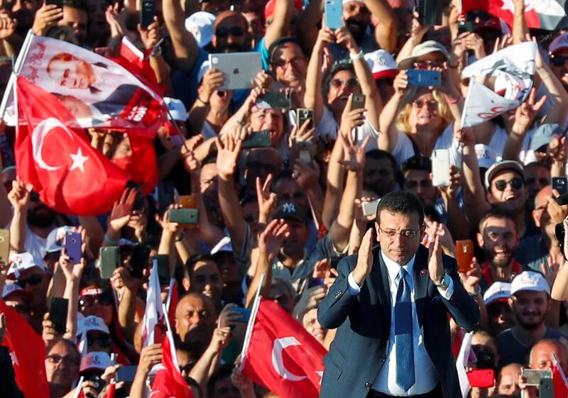 Mr Imamoglu gestures as he adresses his supporters. Reuters