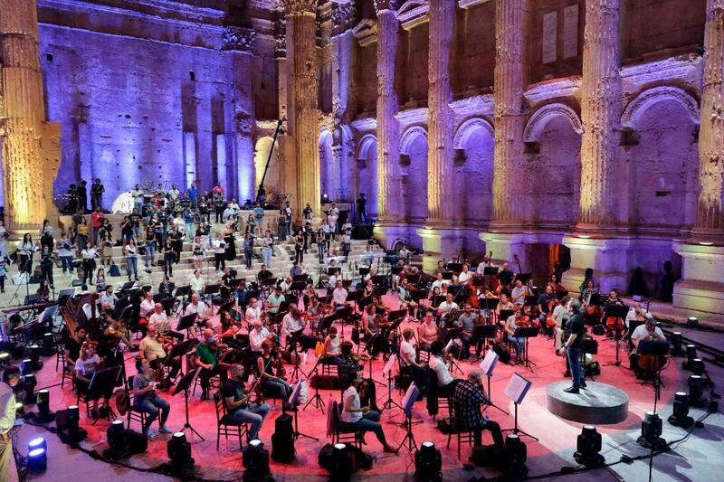 Maestro Harout Fazlian conducts rehearsals ahead of the Sound of Resilience concert inside the Temple of Bacchus at the historic site of Baalbek in Lebanon's eastern Bekaa Valley. AFP