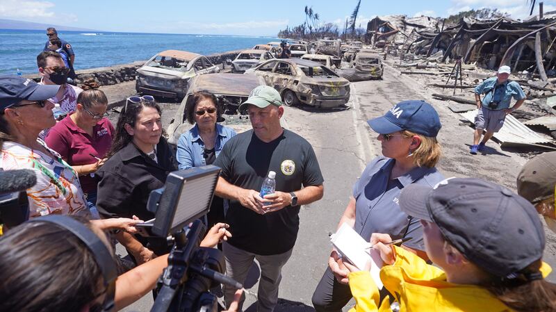 Hawaii Governor Josh Green, centre, speaks to reporters during a tour of wildfire damage in Lahaina, Hawaii. AP 