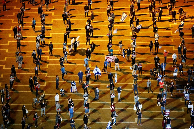 Israelis demonstrate against Israel's Prime Minister Benjamin Netanyahu, under strict restrictions made to slow down the coronavirus  spread, on Rabin Square in Tel Aviv, Israel April 19, 2020 REUTERS