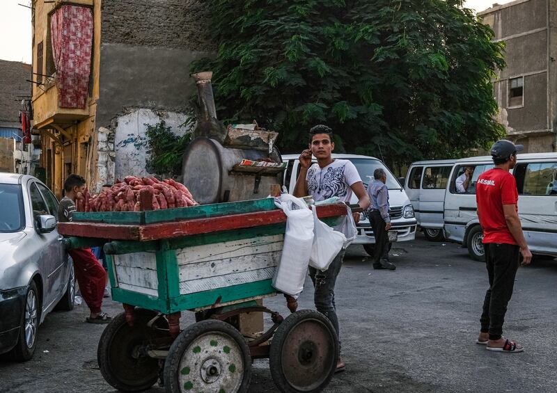 A young man sells roast sweet potato from a cart outside the walls of old Cairo in the historic district of Gamaliya. AFP