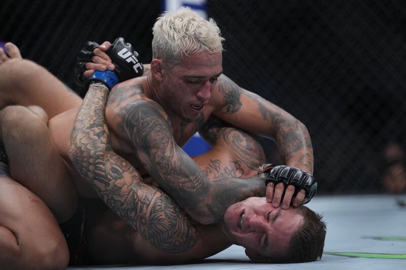 Charles Oliveira pins Dustin Poirier to the mat. Reuters