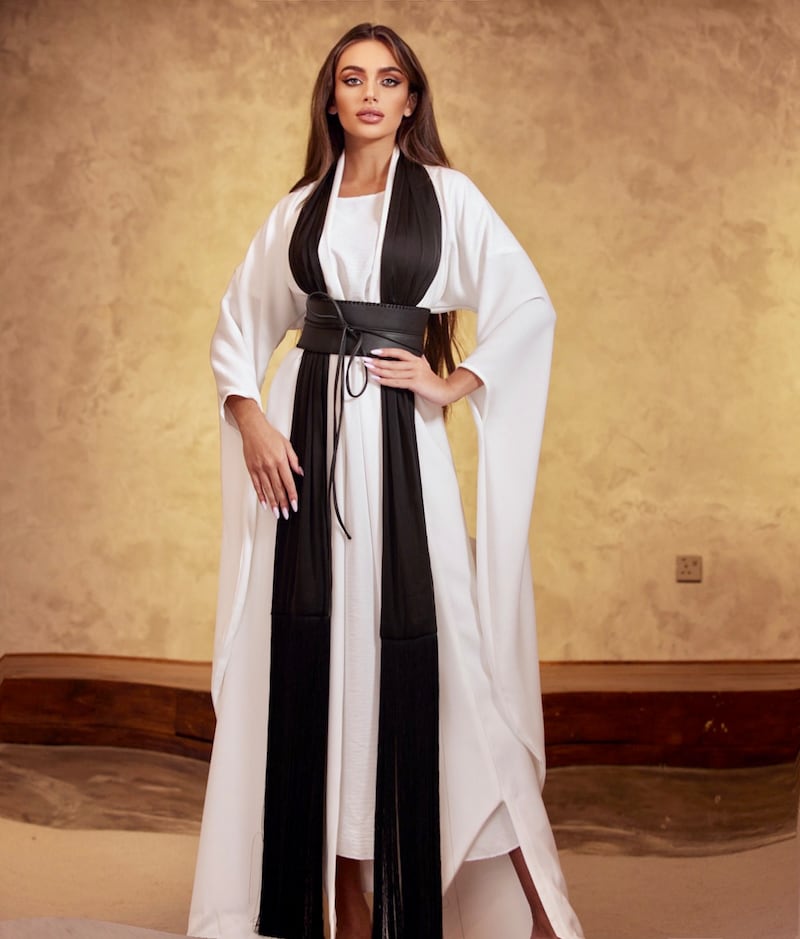 Evlin Khalifa arrived in New Orleans for the Miss Universe pageant wearing a black and white modern abaya by Harvey Cencit. Photo: Miss Universe Bahrain