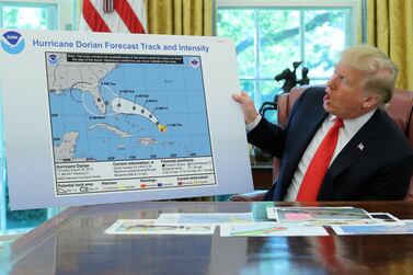 US President Donald Trump with the apparently doctored map of Hurricane Dorian that appears to have been extended with a black line to include parts of the Florida panhandle and the state of Alabama. Reuters