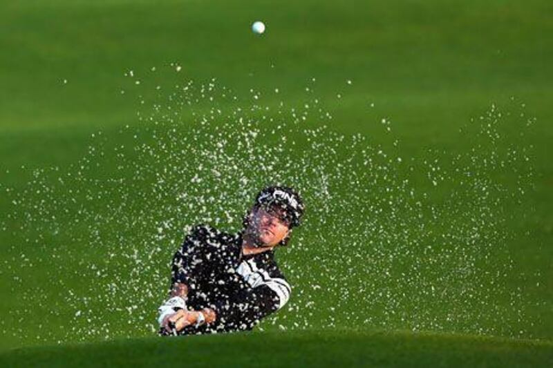 Last year's champion Bubba Watson hits out of a bunker during a practice round for the 2013 Masters at Augusta National yesterday. Mike Ehrmann / AFP