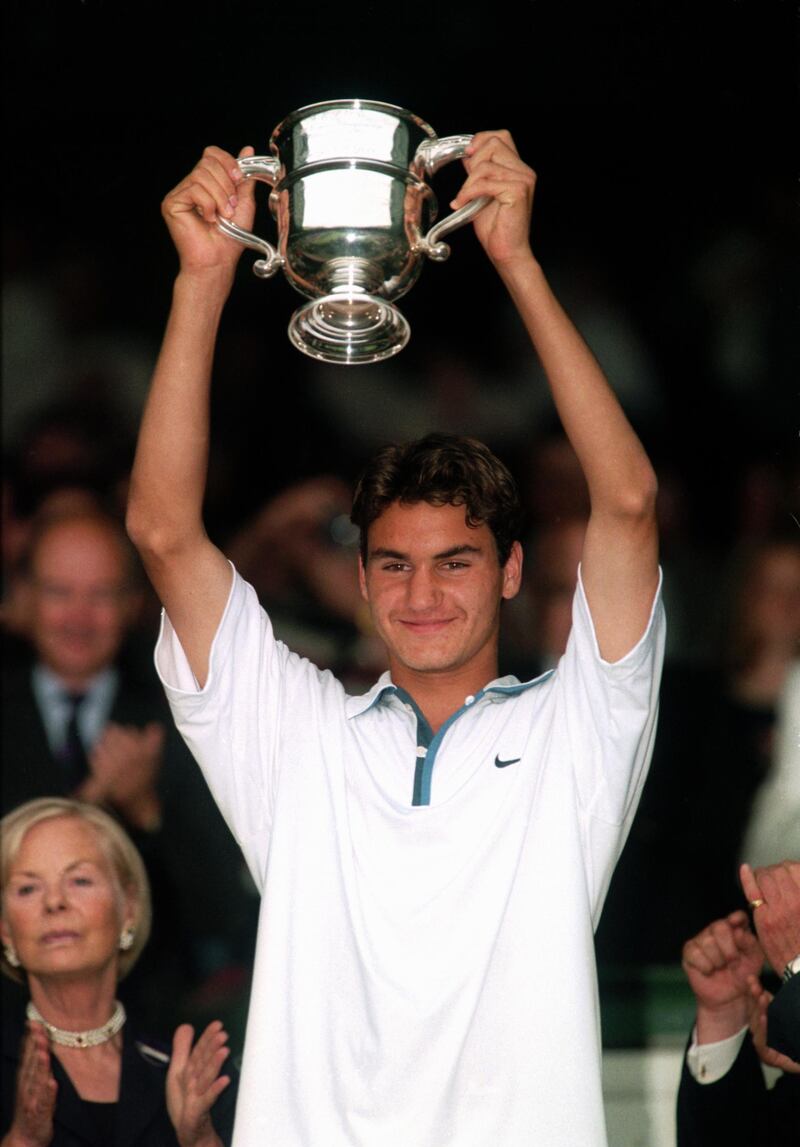 WIMBLEDON, LONDON - JULY 5:  Roger Federer of Switzerland holds aloft the Boys Singles trophy after his win over Irakli Labadze of Georgia in the Boys Singles Final during The Championships at the All England Lawn Tennis Club on July 5, 1998 in London. (Photo by Mike Hewitt/Getty Images)  