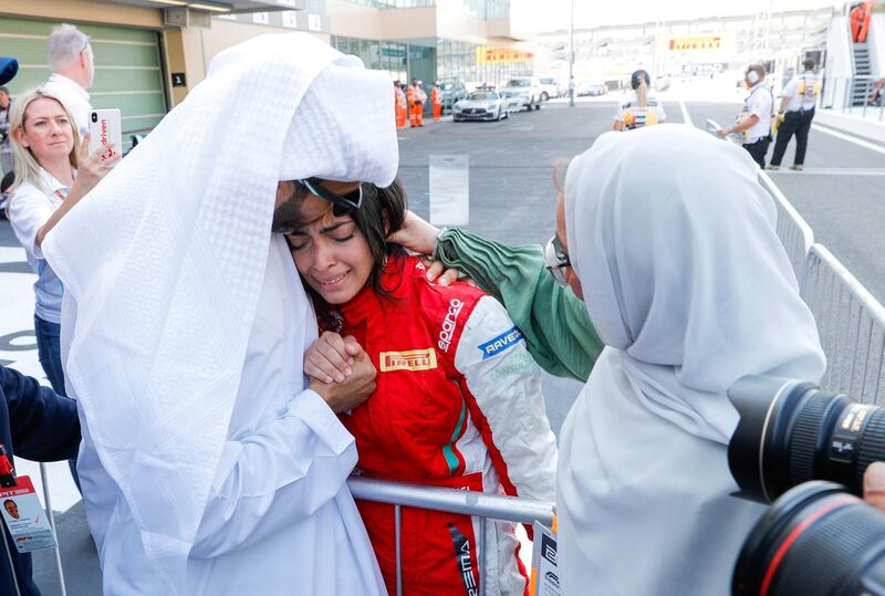 Abu Dhabi, United Arab Emirates, November 30, 2019.  
Formula 1 Etihad Airways Abu Dhabi Grand Prix.
-- FIA F4 Race 1.  Amna Al Qubaisi in tears of joy after taking the win as her father, Khaled and mother Kawter comfort her.
Victor Besa / The National
Section:  SP
Reporter:  Simon Wilgress-Pipe