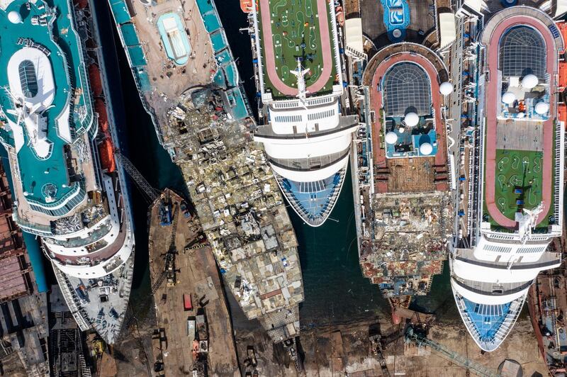 IZMIR, TURKEY - OCTOBER 02: In this aerial view from a drone, five luxury cruise ships are seen being broken down for scrap metal at the Aliaga ship recycling port on October 02, 2020 in Izmir, Turkey. With the global coronavirus pandemic pushing the multi-billion dollar cruise industry into crisis, some cruise operators have been forced to cut losses and retire ships earlier than planned. The cruise industry has been one of the hardest hit industries with public confidence in cruise holidays plummeting after a series of outbreaks occurred on cruise liners as the pandemic spread. The crisis however has bolstered the years intake of ships at the Aliaga ship recycling port with business up thirty percent on the previous year.  (Photo by Chris McGrath/Getty Images)