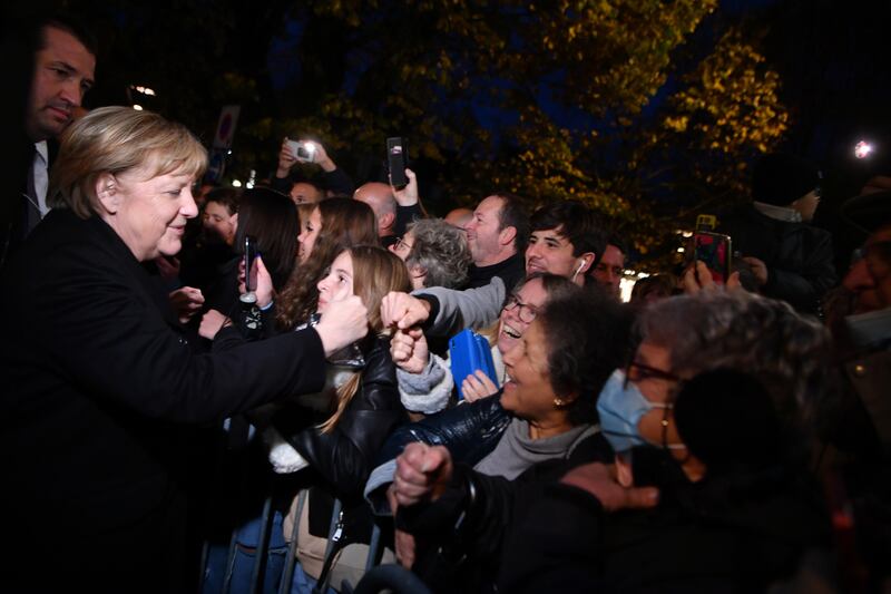 Angela Merkel is greeted by members of the public in Beaune. EPA