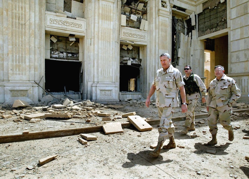 Gen Tommy Franks (c) visits a palace of Saddam Hussein in Baghdad on April 16, 2003. Getty Images