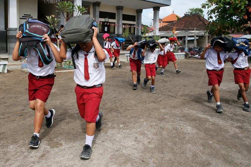 Indonesian students take part in an earthquake and tsunami evacuation drill in Bali. Made Nagi / EPA