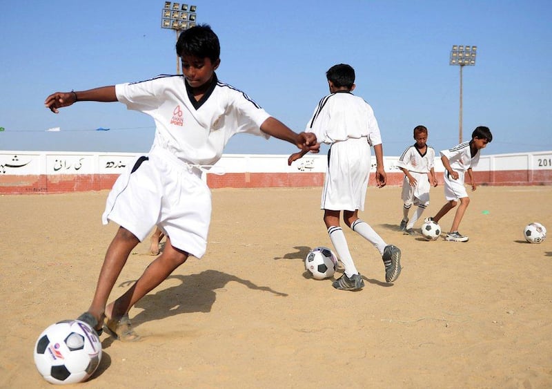 Pakistani youth participate in a training session at a local stadium in Karachi as they participate in an academy program funded by the Real Madrid Foundation. Asif Hassan / AFP