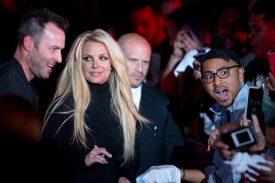 Singer Britney Spears signs autographs for fans during an appearance in front of the Park MGM hotel-casino in Las Vegas, Thursday, Oct. 18, 2018. Spears announced her new residency at the Park MGM's Park Theater beginning in February 2019. (Steve Marcus/Las Vegas Sun via AP)