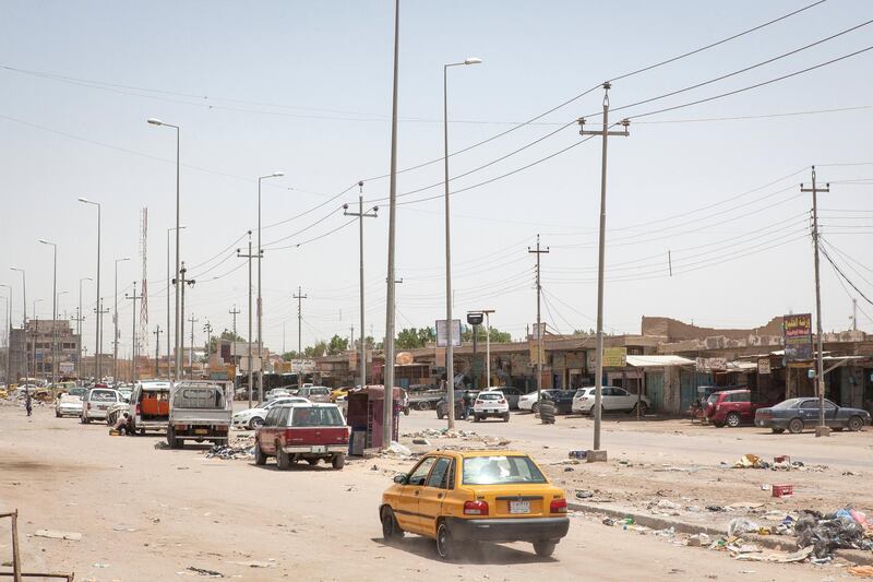 A car drives along a street of Basra, a major city in south Iraq. Photo by Sebastian Castelier