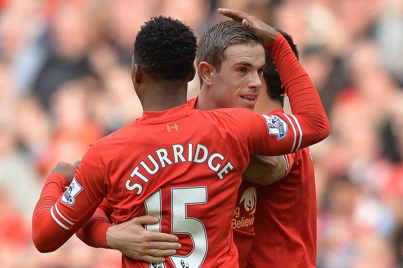 Liverpool FC midfielder Jordan Henderson, right, is congratulated by striker Daniel Sturridge after Henderson scores Liverpool's fourth goal at Anfield on Sunday. Paul Ellis / AFP / March 30, 2014