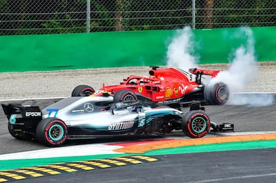 Mercedes' Finnish driver Valtteri Bottas (front) drives past Ferrari's German driver Sebastian Vettel's car after Vettel crashed with Mercedes' British driver Lewis Hamilton during the Italian Formula One Grand Prix at the Autodromo Nazionale circuit in Monza on September 2, 2018. (Photo by GIUSEPPE CACACE / AFP)