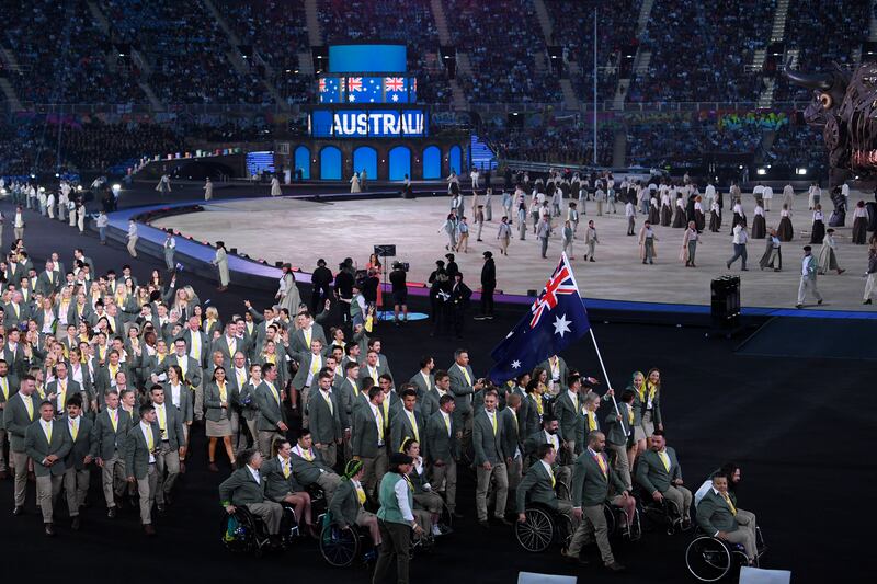 Eddie Ockenden and Rachael Grinham, flag bearers of Team Australia, lead their team out during the Opening Ceremony. Getty