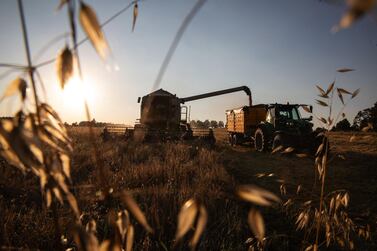 A combine harvester unloads a harvest of barley grain into a trailer at Simanov in the Czech Republic. Lower commodities prices mean a tighter funding market is not yet a major issue but if prices rise so will commodities' traders need for finance. Bloomberg.