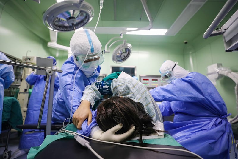 A doctor comforts a pregnant woman infected with coronavirus at an isolation ward in Xiehe Hospital in Wuhan, China. AFP